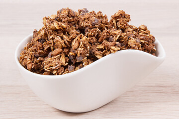 Oat flakes with chocolate in bowl, healthy food for breakfast concept