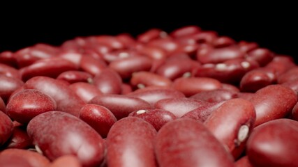 MACRO: Dry red beans grains. Healthy food. Black background