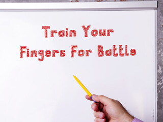 Lifestyle concept about Train Your Fingers For Battle with inscription on the sheet.