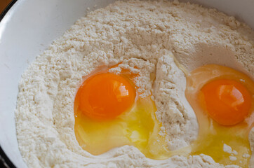 Raw chicken eggs and flour.