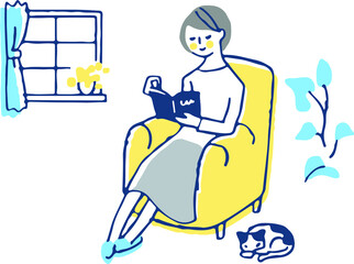 ソファに座って本を読んでいる女性