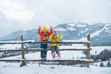 Little kids in the mountains. Traveling with children. Vacation in the winter.
