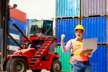 Foreman is giving a signal to work in the harbor. To move the cargo container onto the ship.  Foreman looking forward on Forklifts in the Industrial Container Cargo freight ship.