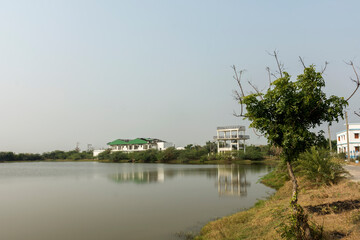 A white house just beside a beautiful lake.