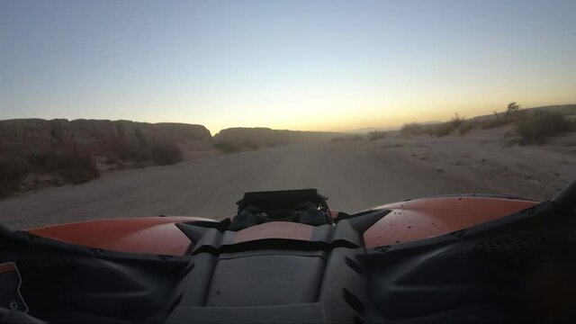 Driving and Offroad vehicle down a desert road