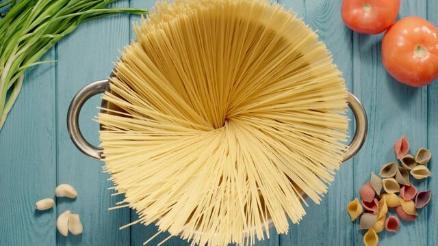 Chef Puts Spaghetti Into Stainless Saucepan While Cooking, Top view