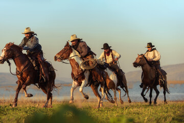 Cowboy riding a horse carrying a gun - Powered by Adobe