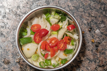 Natural vegetable salad served in a metal casserole dish