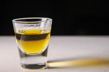 The Lone Shot of Liquor Casting a Gold Shadow