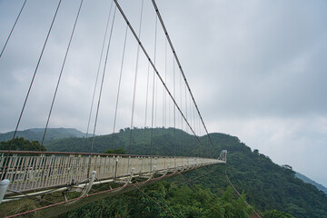 Fototapeta na wymiar The suspension bridge connects the two mountains. Tea, bamboo, betel nut tree, Cattle Egret migration, Chiayi County Meishan Township features, Taiwan.