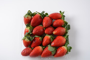 Strawberry fresh organic fruit. Strawberries with leaves. Isolated on a white background.