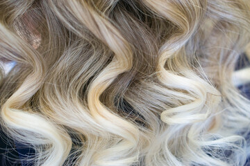 Blond curly hair background  . beauty salon concept .
