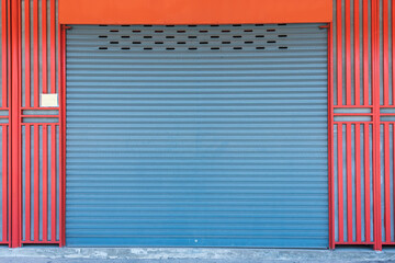 Closed steel shutter door of warehouse, storage or storefront for background and textured.