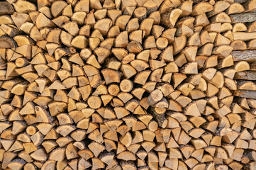 Wall of chopped firewood, Background of dry chopped firewood logs in a pile