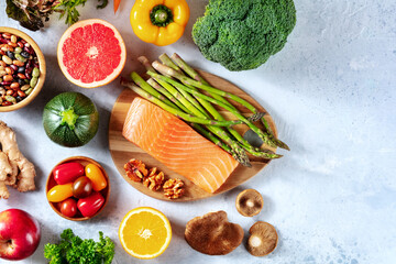 Healthy diet overhead flat lay shot with copy space. Salmon with vegetables, fruits, and mushrooms
