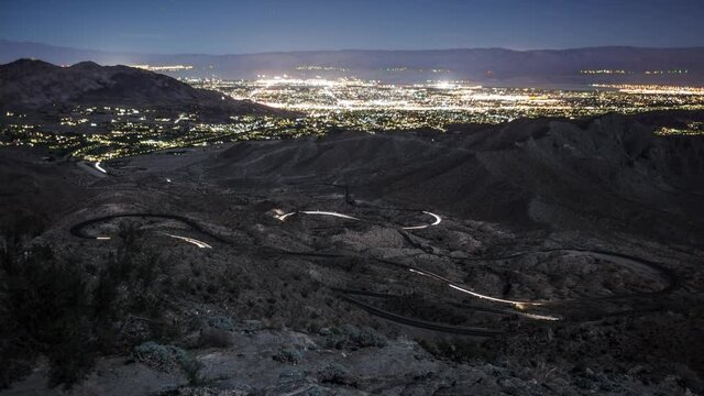 Time-Lapse of traffic along a very winding road into the mountains above Palm Springs. The lights of Palm Springs can be seen in the Distance.