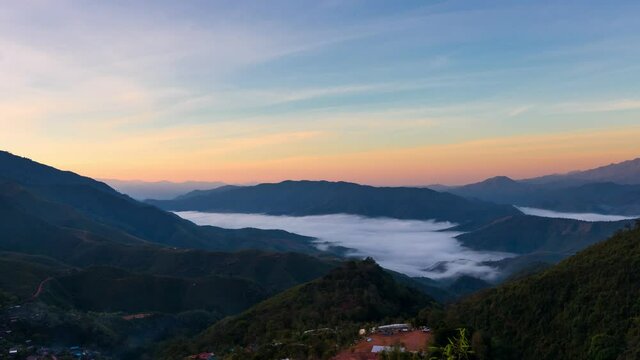 Time lapse view of majestic mist foggy flowing around the mountains in morning at Huai Thon Village, Nan, Thailand.