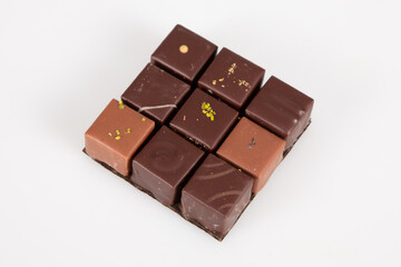 many mix of fine artisanal chocolate candies top view in white background