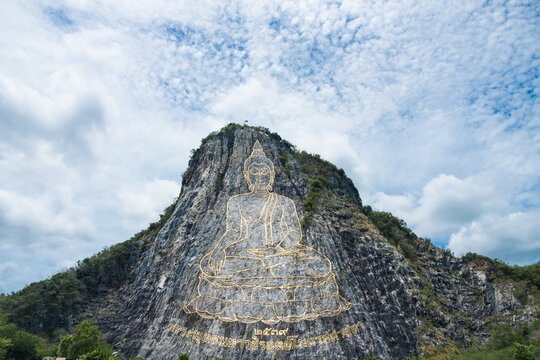 Carved golden Buddha laser image 130 mtr high on the cliff at Khao Chee Chan, Thailand
