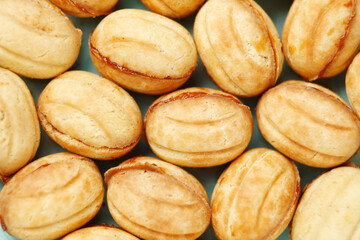 Sweet national Russian nuts with condensed milk in children's hands.