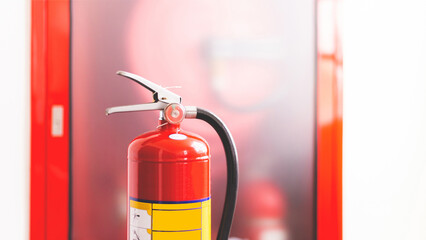 Obraz premium The red fire extinguisher is ready for use in case of an indoor fire emergency.