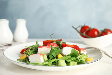 Tasty crab stick salad served on white table, closeup. Space for text