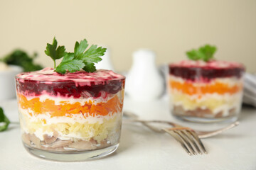 Herring under fur coat served on white table, space  for text. Traditional russian salad