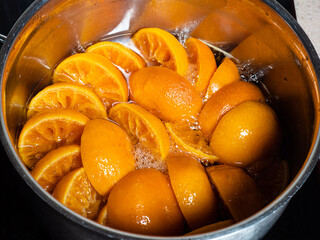 boiling of tangerine jam (varenye) in stewpot on hob at home kitchen