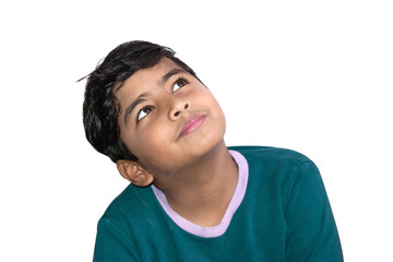 Portrait of a little Asian Indian boy looking up and thinking isolated on white background.
