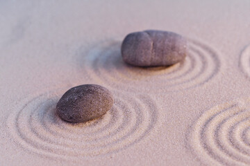 Zen garden stones on sand with ornament