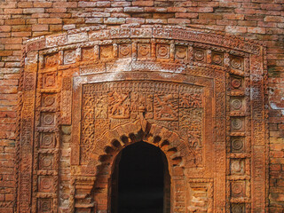 Beautiful carved terracotta with Ramayana battle scene on entrance porch of Chota Anhik Mandir ancient temple in Puthia, Rajshahi district, Bangladesh