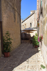 Restaurant tables in the narrow street of Erice