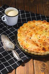 apple pie with milk on a wooden background. Rustic style.