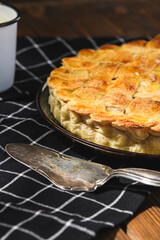 apple pie with milk on a wooden background. Rustic style.