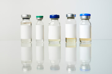vials of vaccine lined up on a white background. copy space