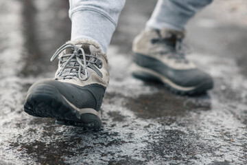 People slides on path. Icing on sidewalk, slippery ice-crusted ground.