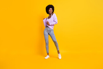 Fototapeta na wymiar Full length photo of adorable carefree dark skin lady look empty space isolated on yellow color background