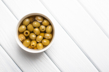 Green pickled olives heap in the bow