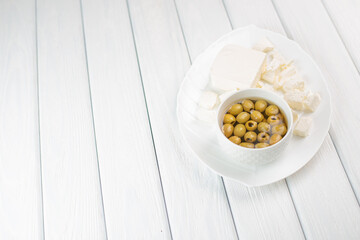 Green pickled olives heap in the bow