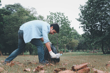 A man picking up trash And cleaning in the public park.