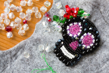 Unfinished brooch skull in style of los muertos made of beads and felt, glass beads and sequins 
