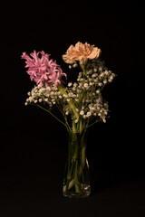 Bouquet of flowers in a vase on a black background