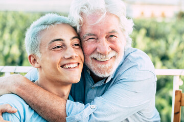 Father and son or grandfather and grandson together hug and enjoy with smile - cheerful different...