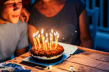 Birthday night party for yoiung teenager and family around - concept of holidays and festive event...