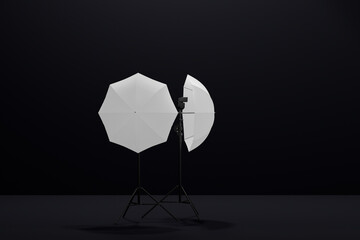 Photography studio lighting stand with flash and umbrella isolated on black