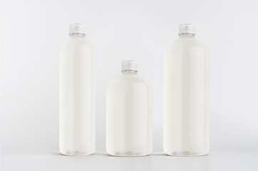 Set of different size plastic tall, low and thick bottles with water, silver cap mockup on white background, template.