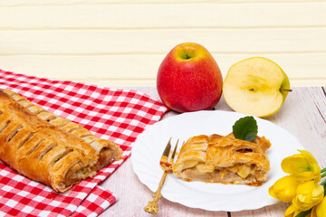 Apple roll served. A roll of homemade baked fresh apple strudel with an appetizing slice of apple...