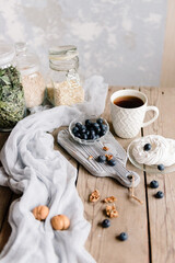Fresh blueberries in a glass bowl on a wooden background. Organic blueberry fruit. Blueberry antioxidant. The concept of healthy food and nutrition, breakfast.