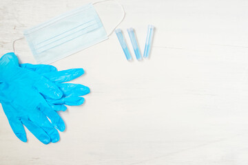 Blue gloves, a protective mask, a syringe and a drug.
