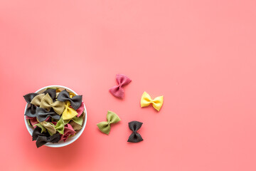Top view of coloured farfalle pasta in bowl